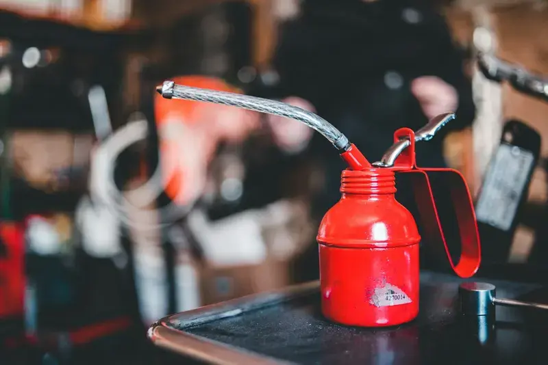 Red and silver steel container on black table