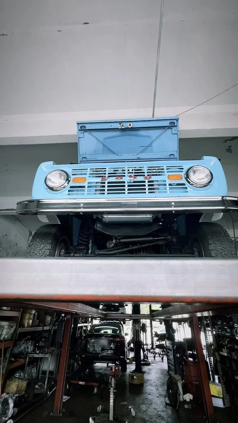 Classic Ford Bronco on the lift in the service bay